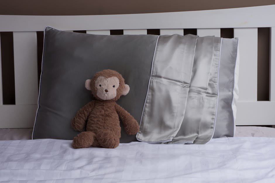 Plush monkey toy on a silk pillowcase, creating a cozy and inviting bedroom vibe.