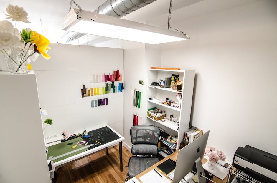 Elegant and organized creative workspace featuring design materials and office equipment, perfect for innovative work.