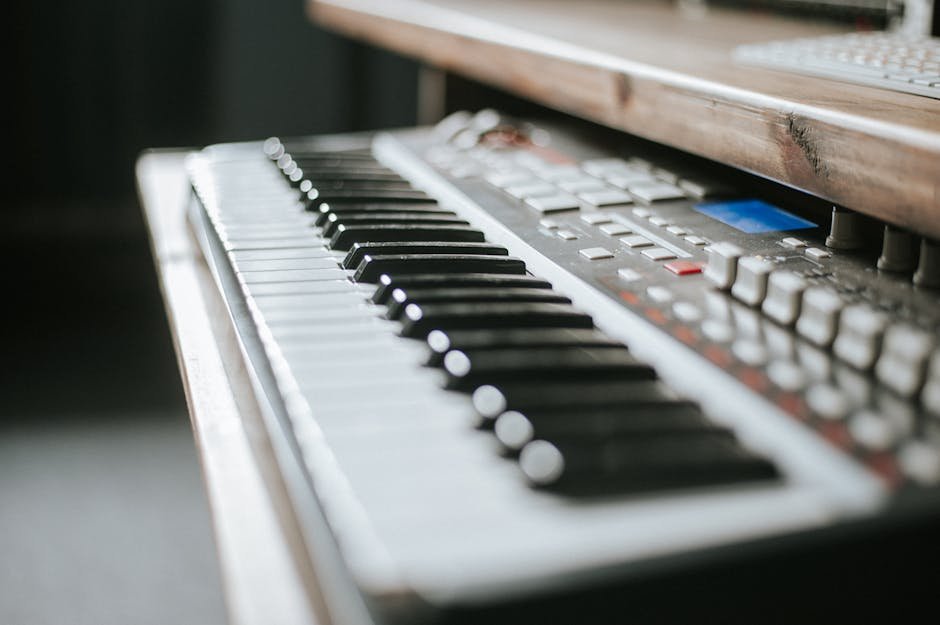 Detailed view of an electronic keyboard in a music production studio setting.
